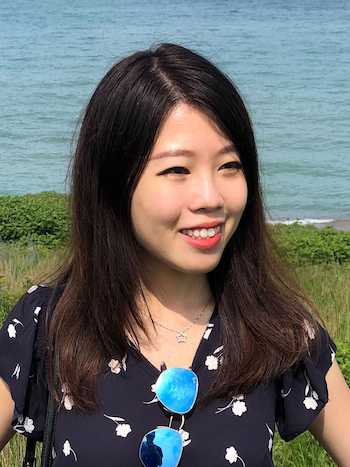 Weiwei headshot, wearing black top with the lake in the background