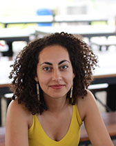 Sylvia's headshot wearing a yellow tank top shirt