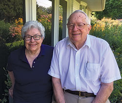 Image of Yvonne and William sitting next to each other, outside on a patio