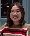 Yijing's headshot wearing a red and brown stripped sweater