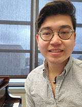 Evan Lee's headshot, wearing glasses and collared shirt.jpg